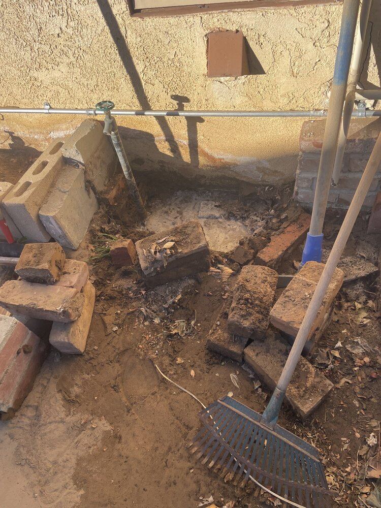 Excavation exposing a supply line during leak repair