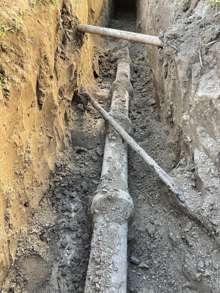 Buried service line exposed in an open trench